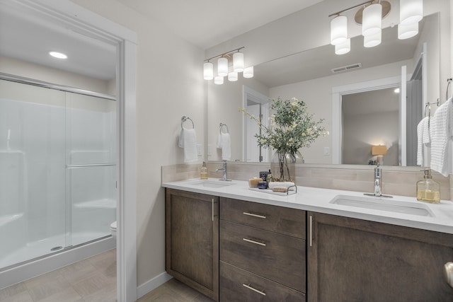 5803 Horn Rd, Missoula, MT 59808 - full bath with a sink, visible vents, a shower stall, and double vanity