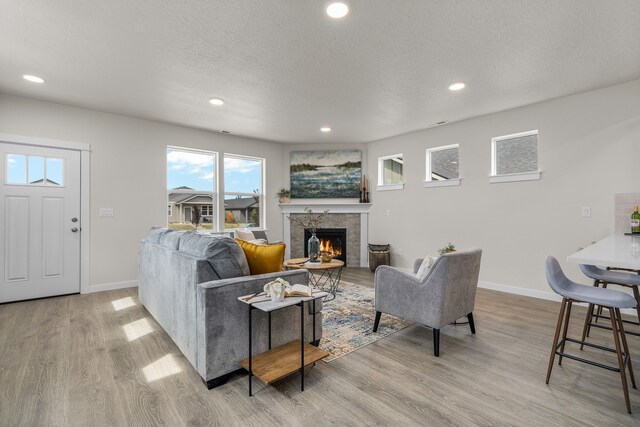 living room with light hardwood / wood-style flooring and a textured ceiling