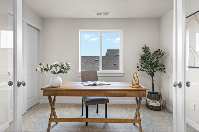 carpeted office featuring french doors