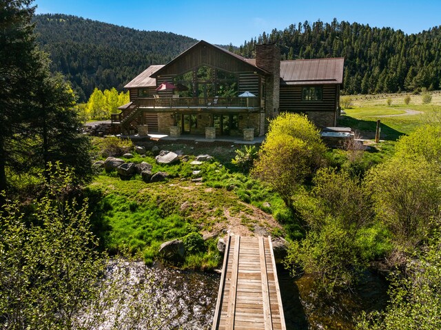 rear view of property with a deck with mountain view