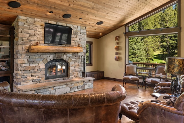 living room featuring light hardwood / wood-style flooring, a fireplace, lofted ceiling, and wooden ceiling