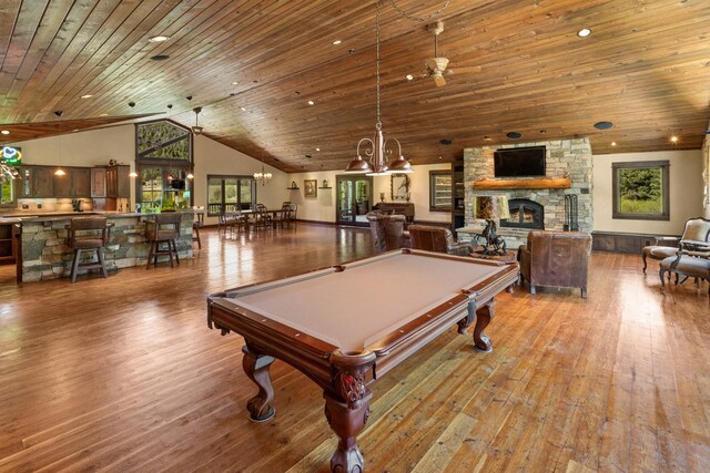 recreation room with a stone fireplace, hardwood / wood-style flooring, billiards, and wooden ceiling