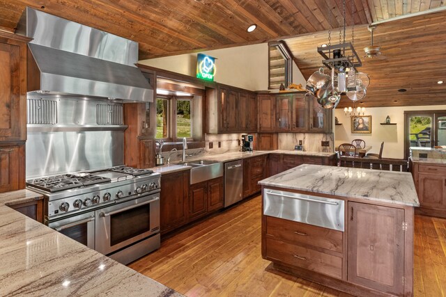 kitchen with light stone counters, light hardwood / wood-style floors, a kitchen island, stainless steel appliances, and wooden ceiling