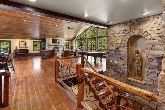 interior space with lofted ceiling with beams and hardwood / wood-style floors