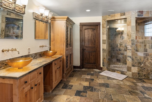 bathroom featuring a tile shower and vanity