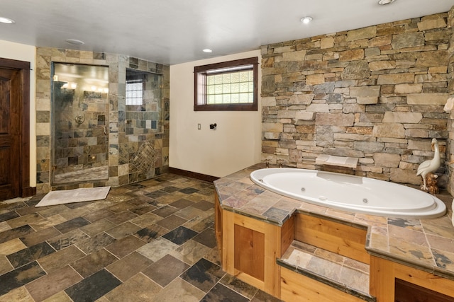 bathroom featuring independent shower and bath