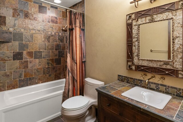 full bathroom with vanity, shower / tub combo, and toilet