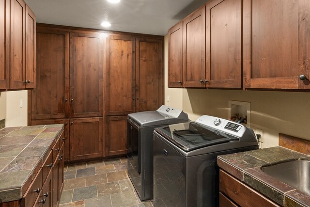 laundry area featuring cabinets and washer and clothes dryer