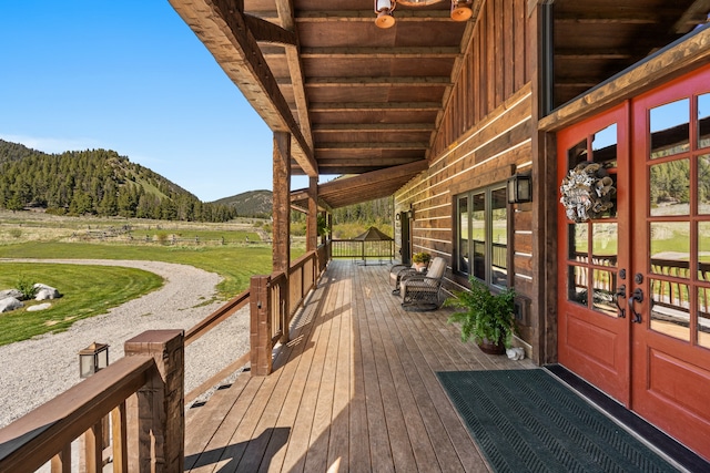 wooden terrace with a mountain view and french doors