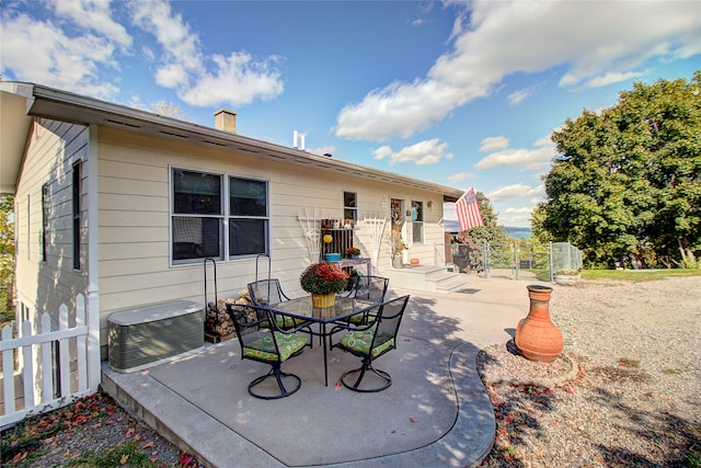 rear view of house featuring cooling unit and a patio