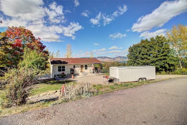 rear view of house featuring a mountain view