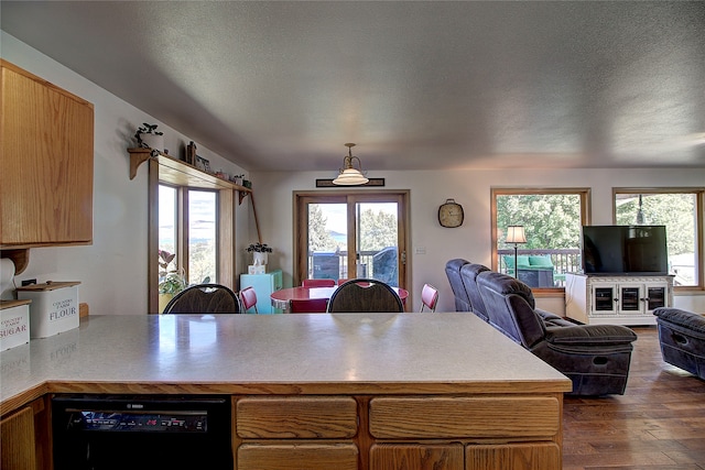 kitchen featuring pendant lighting, a textured ceiling, and dark wood-type flooring