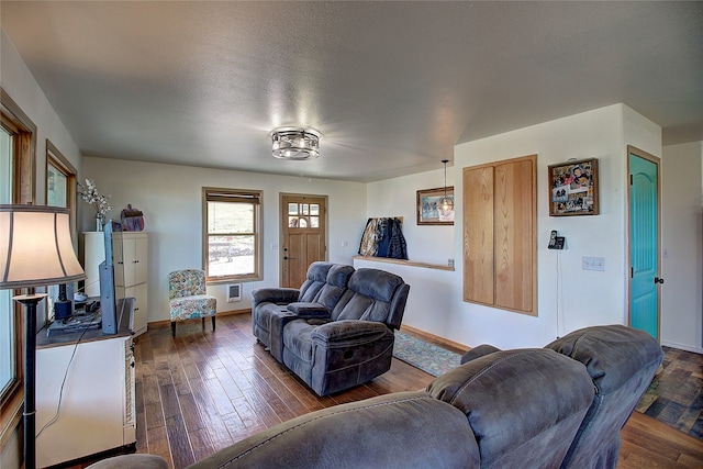 living room featuring a textured ceiling and dark hardwood / wood-style floors