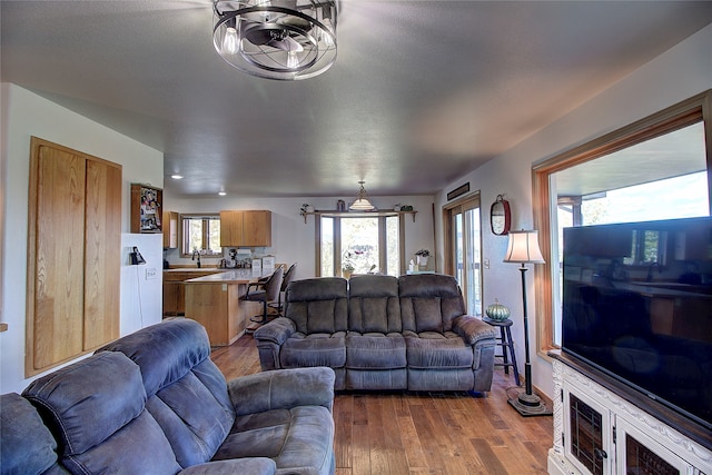 living room with light hardwood / wood-style flooring and sink