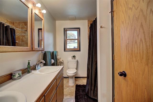 bathroom with a shower with curtain, vanity, toilet, and tile patterned floors