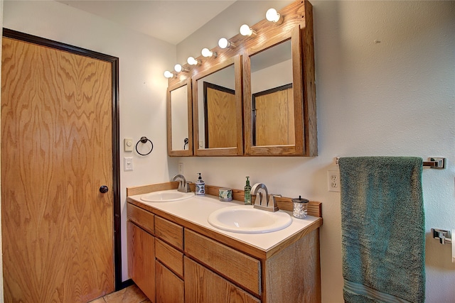 bathroom with tile patterned floors and vanity