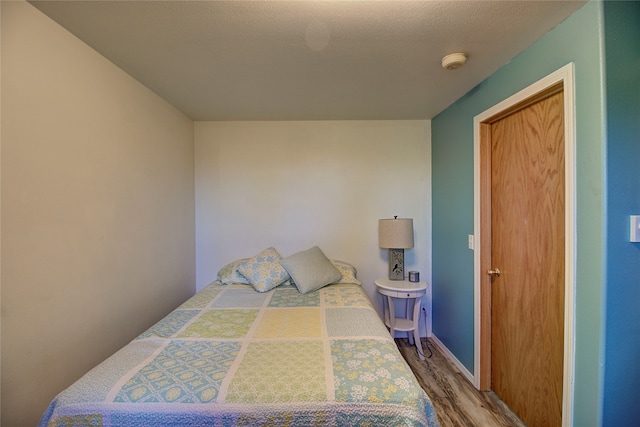 bedroom with hardwood / wood-style flooring