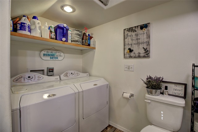 laundry room with hardwood / wood-style floors and washer and dryer