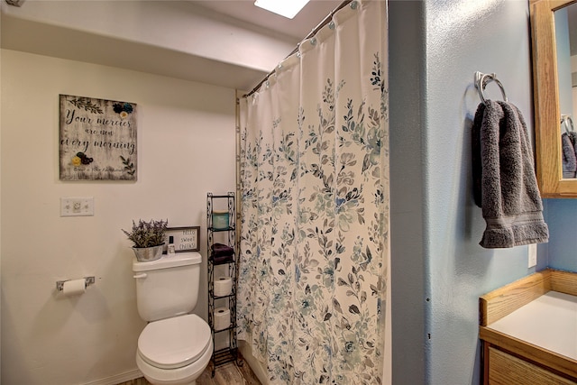 bathroom with a shower with curtain, vanity, toilet, and hardwood / wood-style flooring