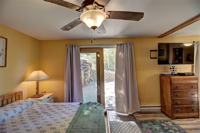 bedroom featuring light hardwood / wood-style flooring, ceiling fan, baseboard heating, and access to outside