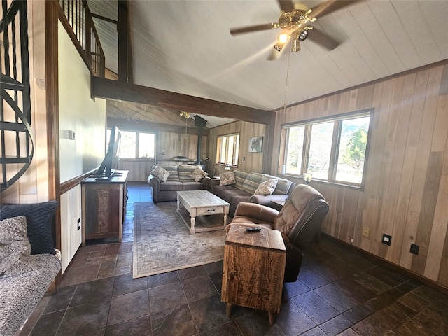 living room with wood walls, ceiling fan, and high vaulted ceiling