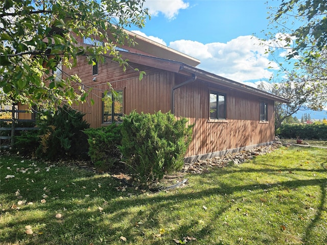 view of home's exterior with a yard