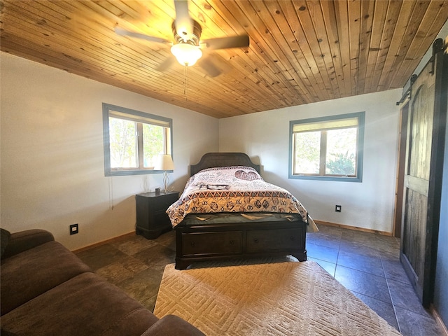 tiled bedroom with wooden ceiling, a barn door, and ceiling fan