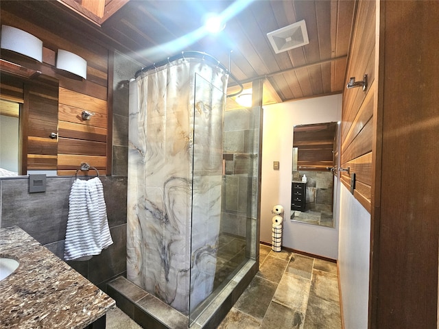 bathroom featuring wooden walls, a shower with curtain, wooden ceiling, and vanity