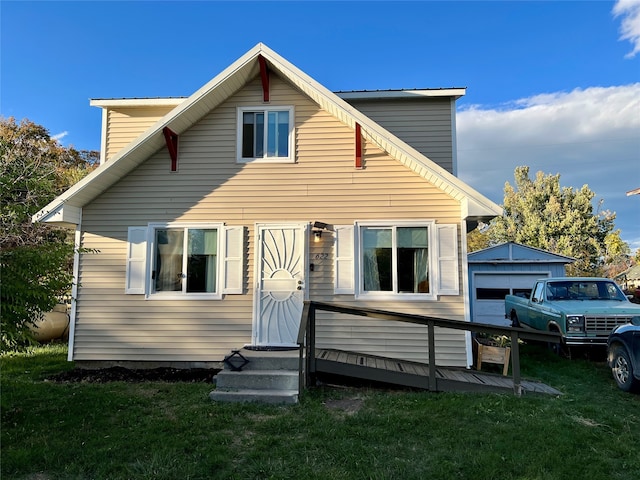 back of house featuring a garage and a yard