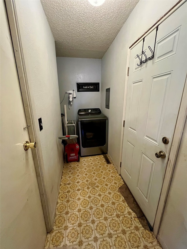 corridor featuring a textured ceiling and washer / dryer