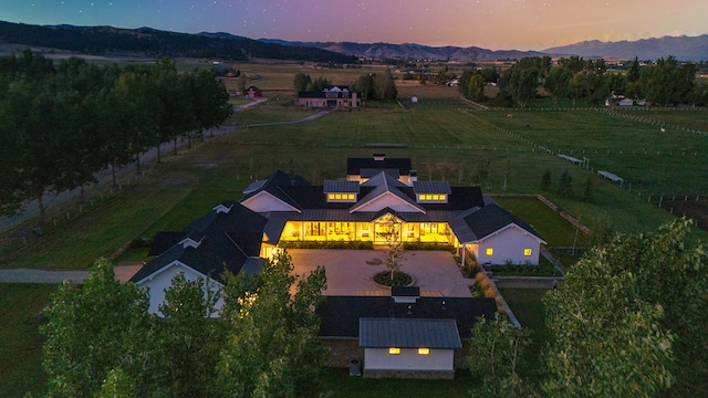 aerial view at dusk featuring a mountain view