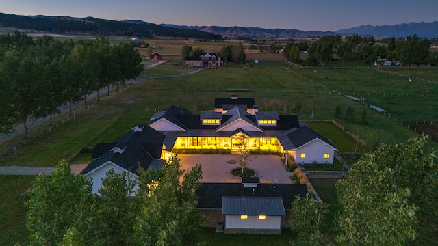 aerial view at dusk featuring a mountain view