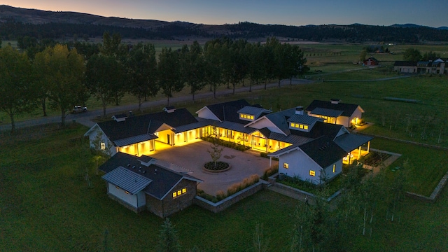 aerial view at dusk featuring a mountain view