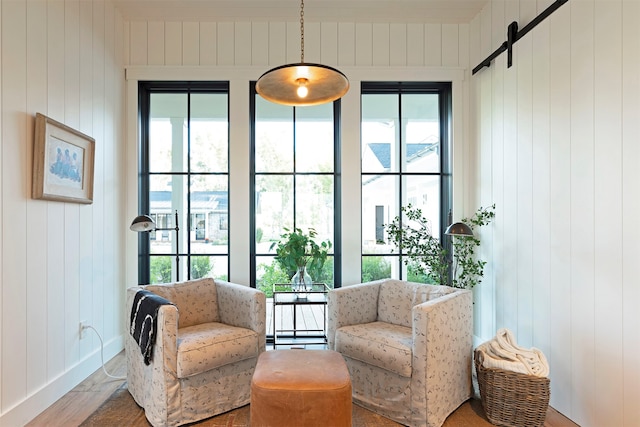 sitting room with wood walls and plenty of natural light