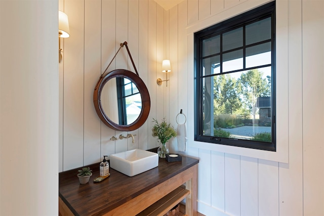 bathroom with wooden walls and vanity