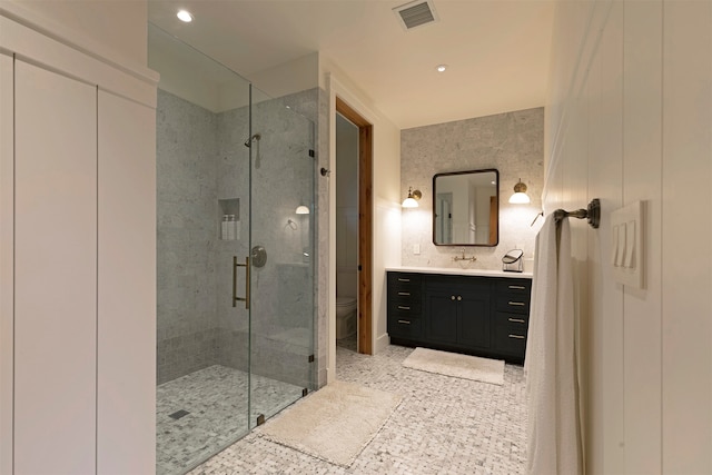 bathroom featuring vanity, toilet, and an enclosed shower