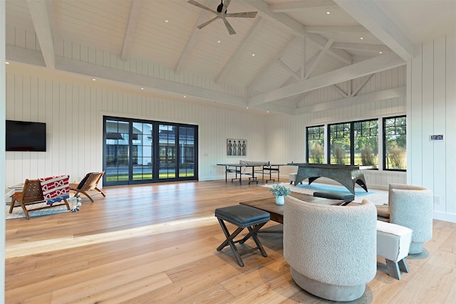 living room featuring light hardwood / wood-style floors, beam ceiling, ceiling fan, and high vaulted ceiling