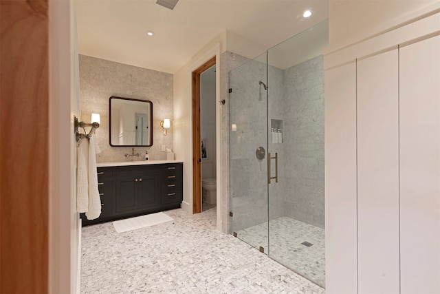 bathroom featuring vanity, toilet, and an enclosed shower