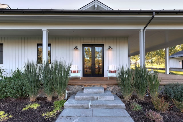 view of exterior entry featuring a carport and french doors