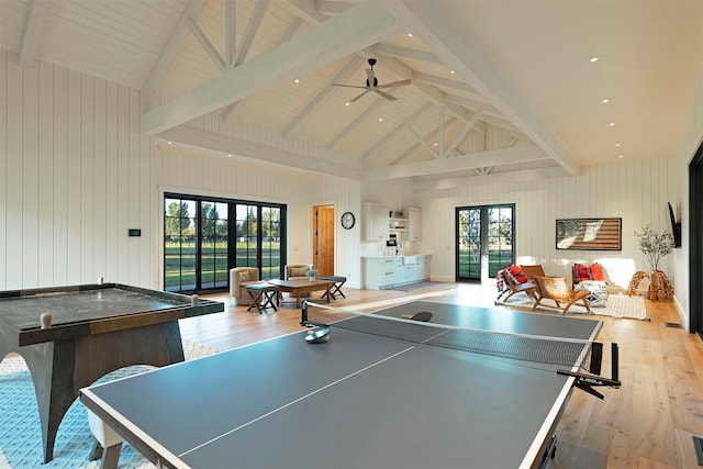 game room featuring high vaulted ceiling, beam ceiling, light hardwood / wood-style floors, and french doors