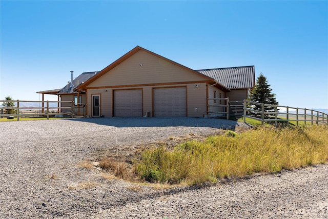 53 Skyview Ln, Townsend, MT 59644 - view of front of house with an attached garage, driveway, and a metal roof