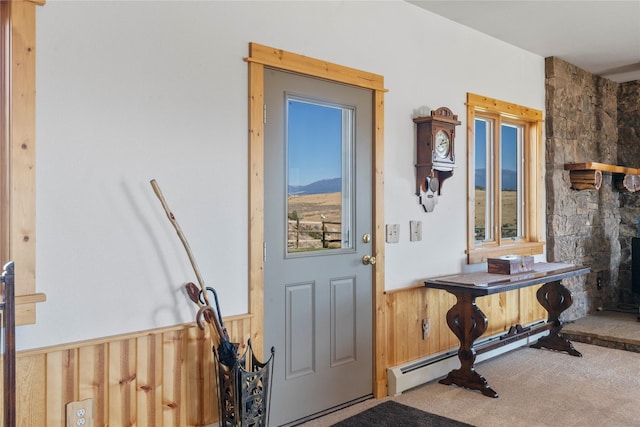 53 Skyview Ln, Townsend, MT 59644 - doorway to outside with wainscoting, carpet flooring, and wood walls