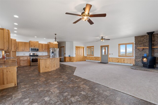 53 Skyview Ln, Townsend, MT 59644 - kitchen featuring appliances with stainless steel finishes, open floor plan, a center island, ceiling fan, and wainscoting