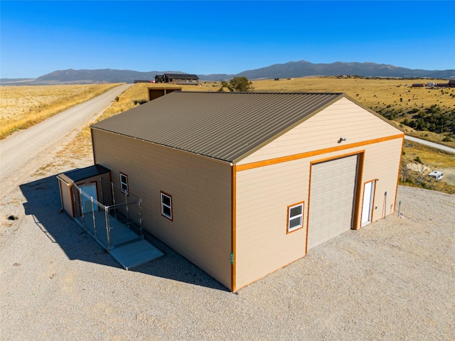 53 Skyview Ln, Townsend, MT 59644 - view of side of home with a mountain view, a garage, a metal roof, and an outdoor structure