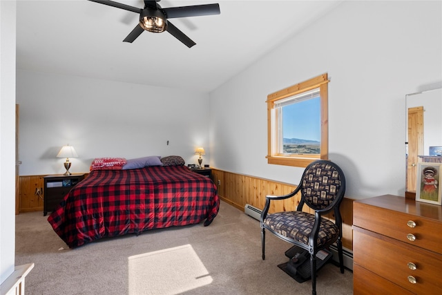 53 Skyview Ln, Townsend, MT 59644 - carpeted bedroom with wainscoting, wood walls, a ceiling fan, and a baseboard heating unit