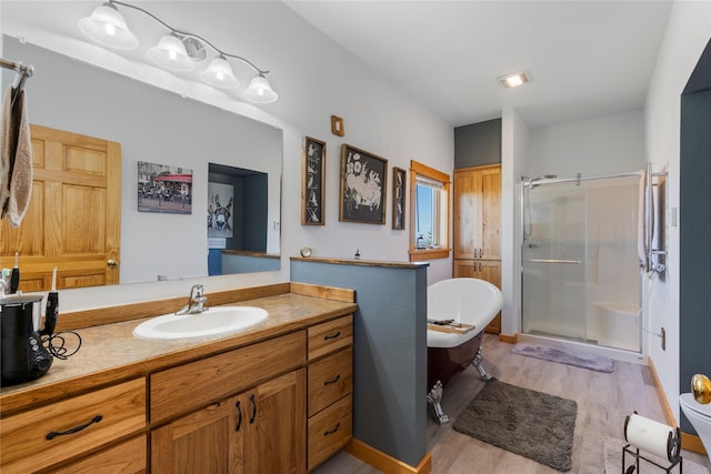 53 Skyview Ln, Townsend, MT 59644 - bathroom with a stall shower, wood finished floors, vanity, and a freestanding tub