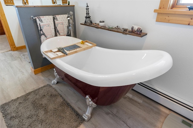 53 Skyview Ln, Townsend, MT 59644 - full bathroom featuring wood finished floors, baseboard heating, and a freestanding tub