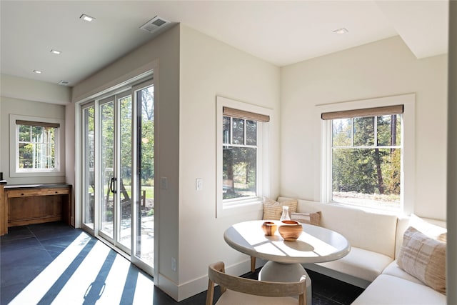 doorway to outside featuring dark tile patterned flooring and breakfast area