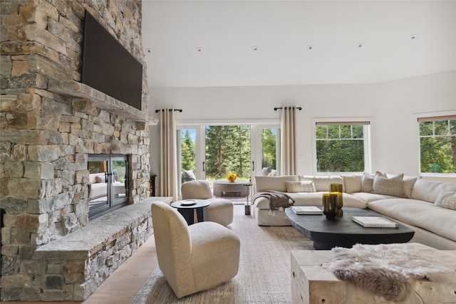 living room featuring light wood-type flooring and a fireplace