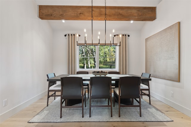 dining space featuring light hardwood / wood-style floors, lofted ceiling with beams, and a chandelier